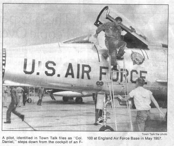 Newspaper account: A pilot identified at Colonel Daniel steps down from the cockpit of an F-100 at Eng at England Air Force Base in May of 1957