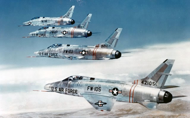 Flight formation of four F-100 Super Sabre jet fighters