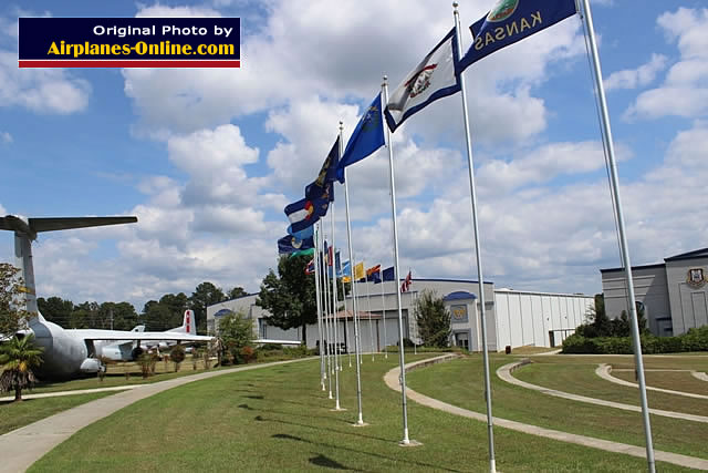 Flags in the outdoor area, with two hangars in the background at the Museum of Aviation at Robins AFB, Georgia