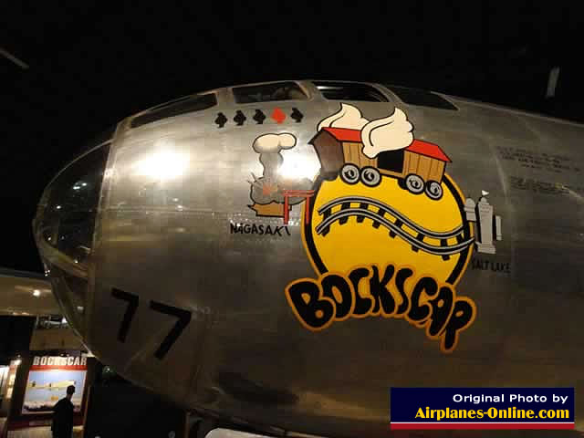 Left nose view of the B-29 Superfortress "Bockscar" showing four black "pumpkin" bombs, and one red "Fat Man" atomic bomb