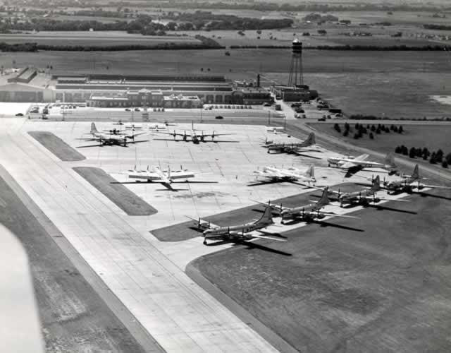Boeing Wichita Plant, aerial view of completed B-29s parked on apron with part of the original Stearman Aircraft plant in the background